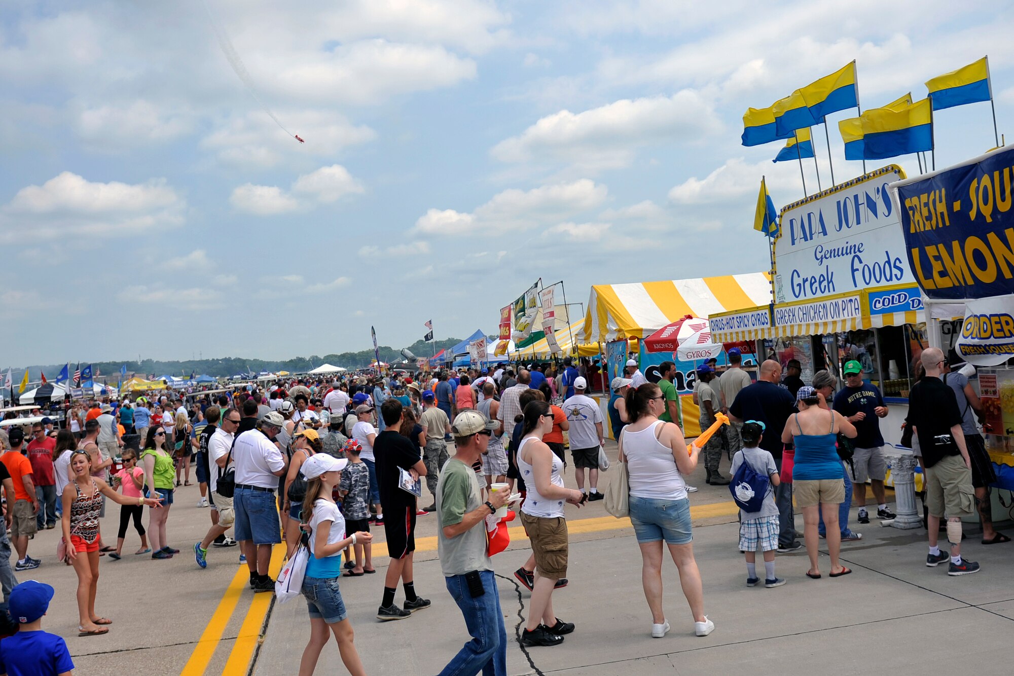 Air show attendees line up for the many vendors for food and refreshments during the 2014 Defenders of Freedom Open House and Air Show July 19 at Offutt Air Force Base, Nebraska. During the two-day event, attendees gathered in record numbers to see the many aerial performers and static displays.  (U.S. Air Force photo by Jeff W. Gates/Released)