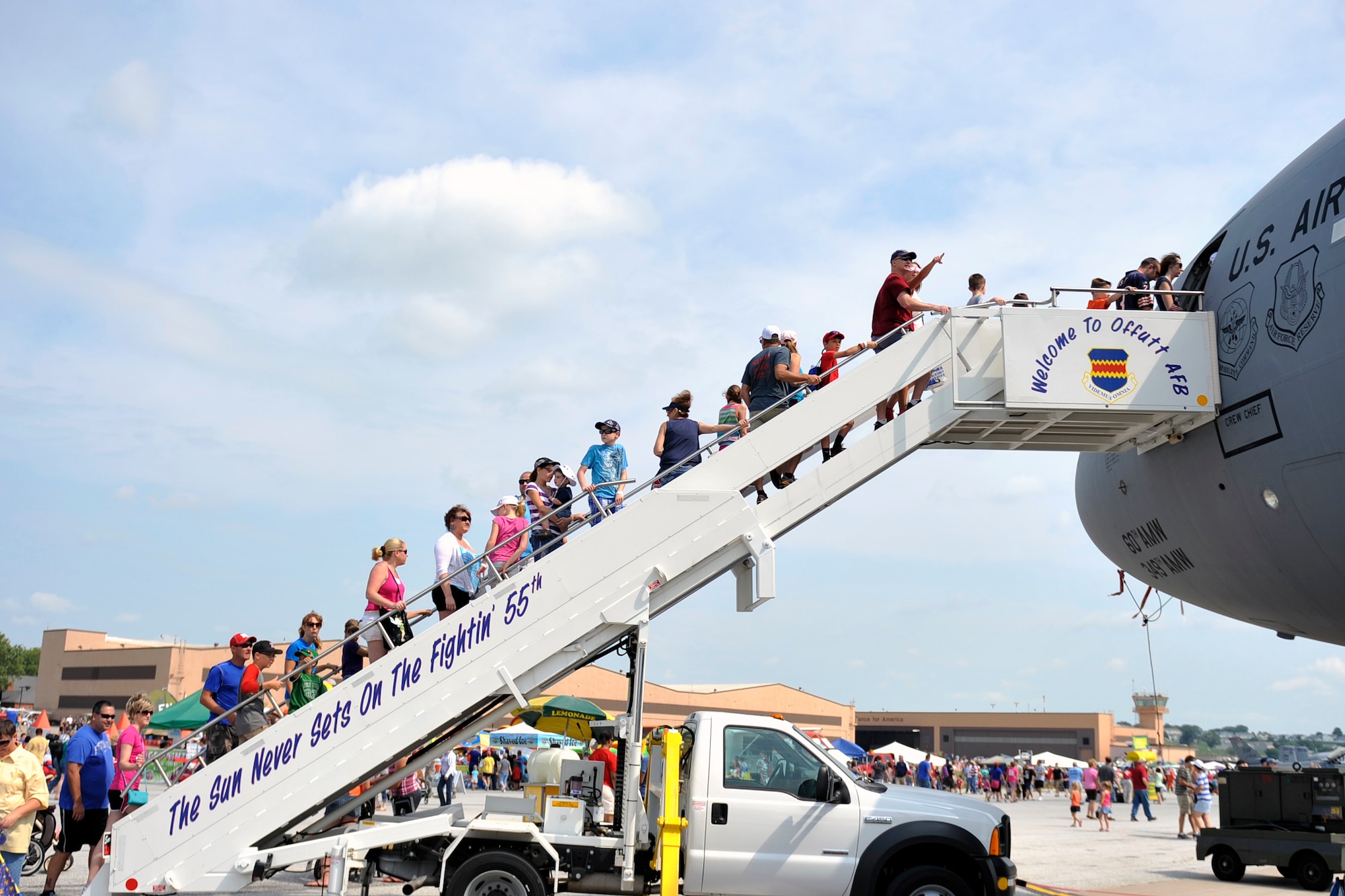Air show attendees climb the stairs to a KC-10 static display at the 2014 Defenders of Freedom Open House and Air Show July 19 at Offutt Air Force Base, Nebraska.  Patrons gathered in record numbers to see the events 25 static displays, 12 air show performers, a variety of vendors and a large Kids Zone area for kids to enjoy.  (U.S. Air Force photo by Jeff W. Gates/Released)