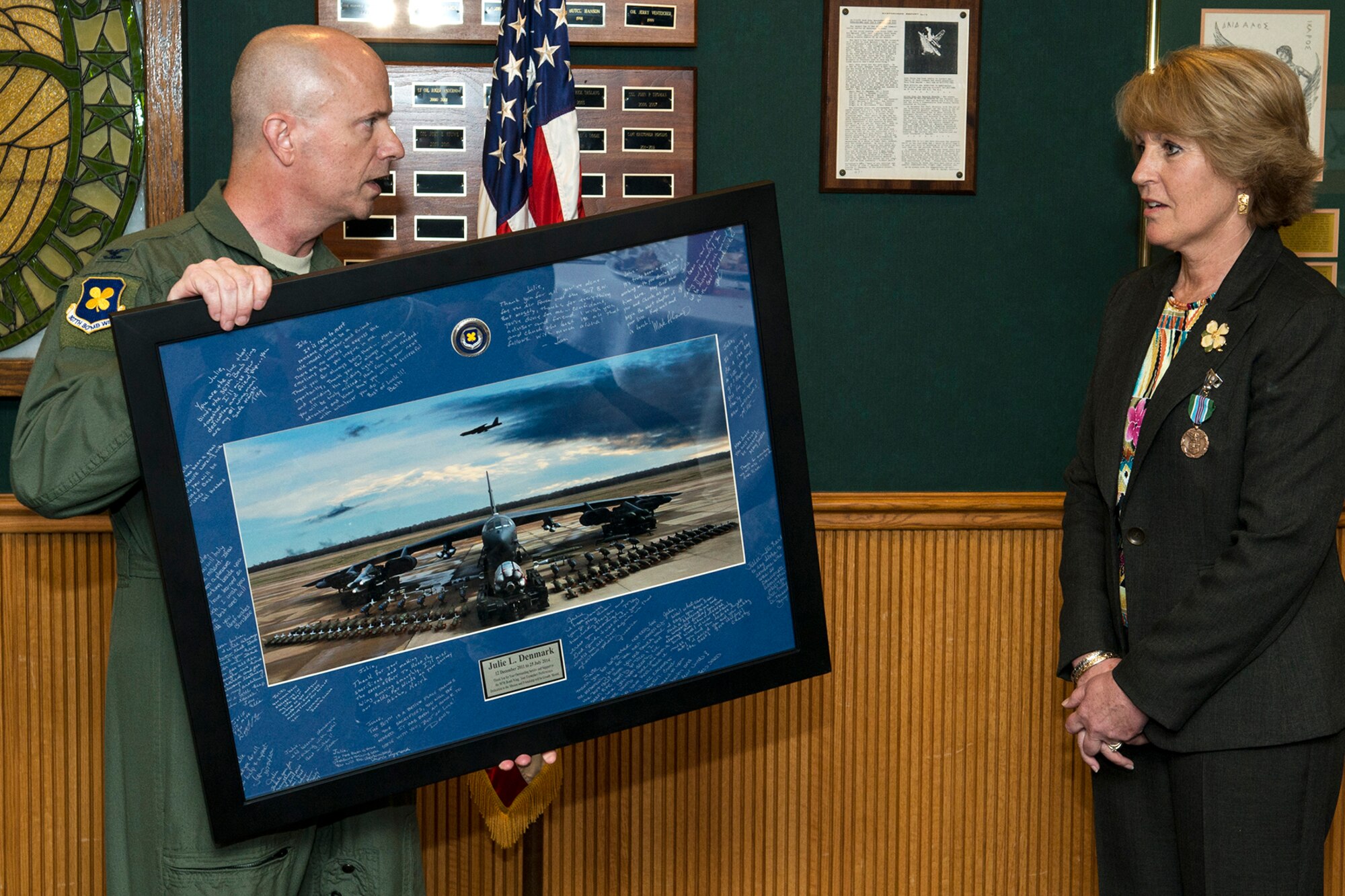 U.S. Air Force Col. Jonathan Ellis, 307th Bomb Wing commander, makes a presentation to Julie Denmark during her farewell luncheon, July 18, 2014, Barksdale Air Force Base, La. Denmark is the secretary for the commander and is leaving Barksdale for a job in the Washington, D.C. area. (U.S. Air Force photo by Master Sgt. Greg Steele/Released)