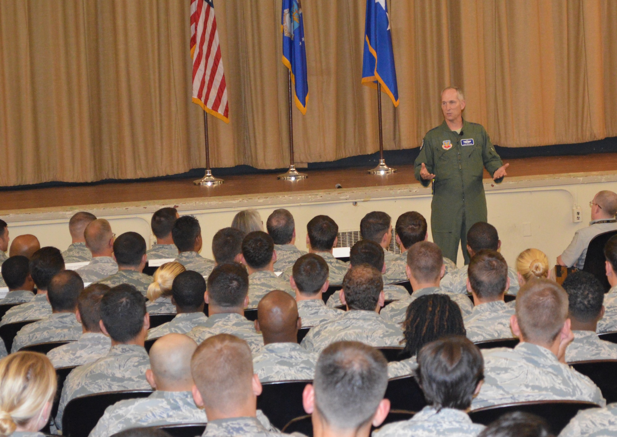 U.S. Air Force General Mike Hostage, commander of Air Combat Command, speaks with Airmen at an all call held at Pope Field, N.C., July 16. Topics discussed included the Tuitions Assistance Program, sequestration, aircraft and air combat. (U.S. Air Force photo by Senior Airman Melissa Dearstone/Released)