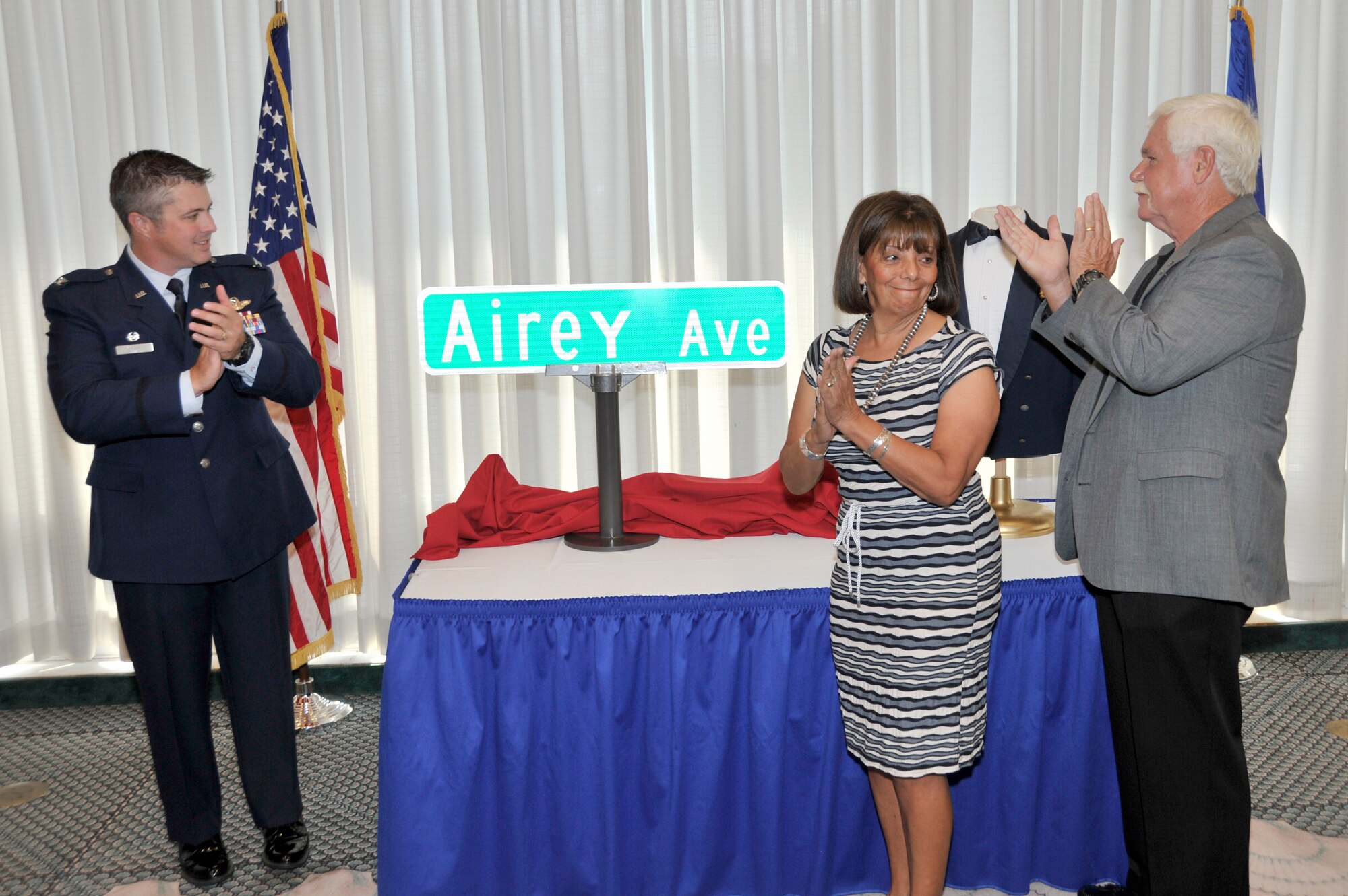 Colonel David E. Graff, 325th Fighter Wing commander, presents the new Airey Avenue street sign to Retired Chief Master Sgt. Dale Airey, son of the first Chief Master Sgt. of the Air Force Paul W. Airey, and his wife, Norma, July 22 during the street renaming ceremony at Tyndall’s Heritage Club. (U.S. Air Force photo by Airman 1st Class Sergio A. Gamboa)