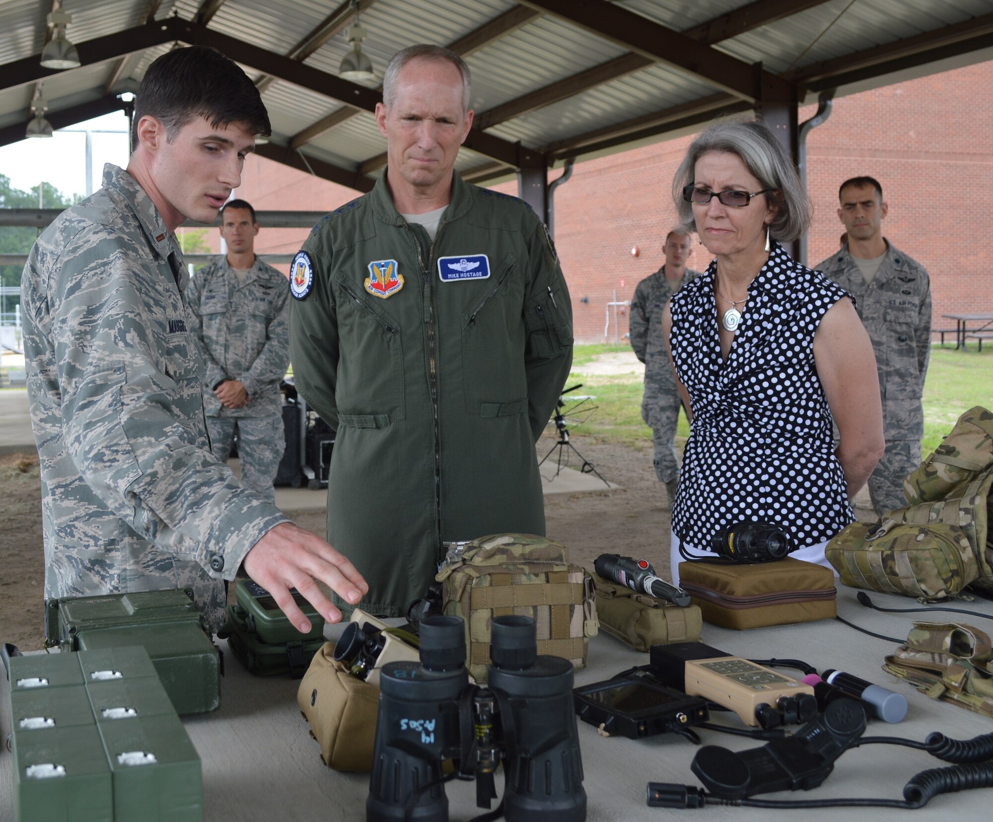 2nd Lt. Matthew Marggraf, 14th Air Support Operations Squadron,Charlie Flight assistant flight commander,  shows U.S. Air Force General Mike Hostage, commander of Air Combat Command, and his wife Kathy Hostage, some of the gear used by the unit during missions while visiting Pope Field, N.C.,  July 16. Hostage also met with 18th Air Support Operations Group  weather forecasters to learn more about their mission and equipment at home stations and during deployments. (U.S. Air Force photo by Senior Airman Melissa Dearstone/Released)