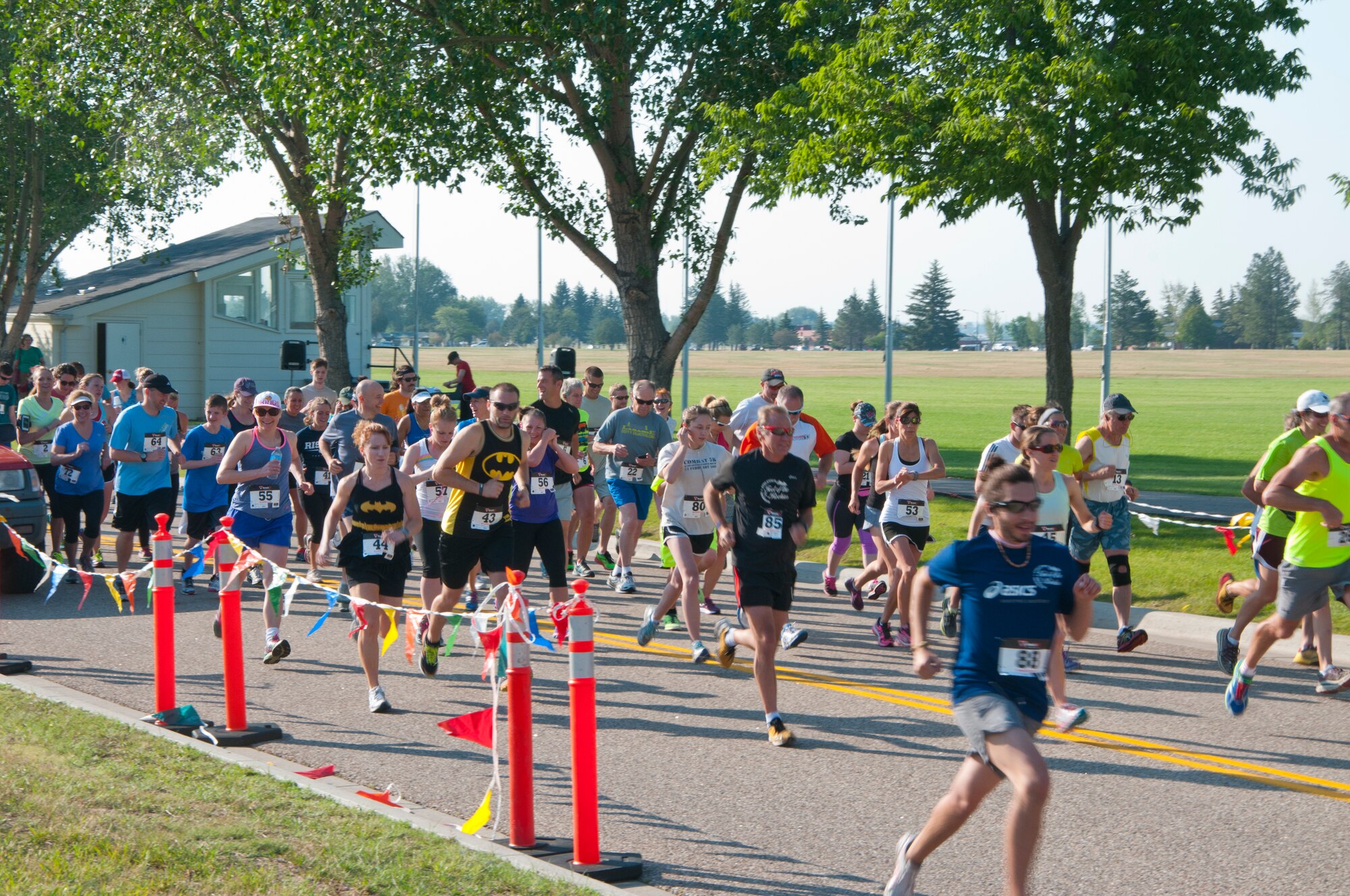 Runners take off at the beginning of the Buffalo Stampede, concurrent 5K and 10K races along F.E. Warren streets, July 19, 2014, near the Argonne Parade Field. Airmen from the 90th Munitions Squadron and Col. Carl Jones, 90th Missile Wing vice commander, sounded the start of the race with cannonfire. (U.S. Air Force photo by Airmen 1st Class Jason Wiese)