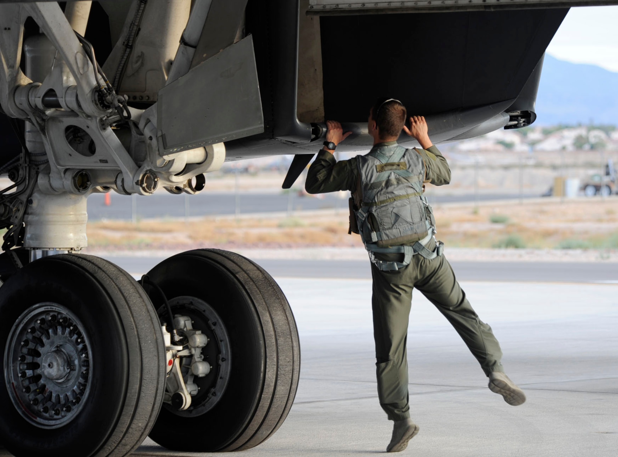 Capt. Andy Lucchesi, 34th Bomb Squadron weapons system officer, performs a walk around inspection prior to launch during Red Flag 14-3 on Nellis Air Force Base, Nev., July 14, 2014. The 28th Bomb Wing is the lead wing for Red Flag this year, which is a realistic combat training exercise aimed to provide real world scenarios within a controlled environment . (U.S. Air Force photo by Tech. Sgt. Jerry Fleshman/Released) 

