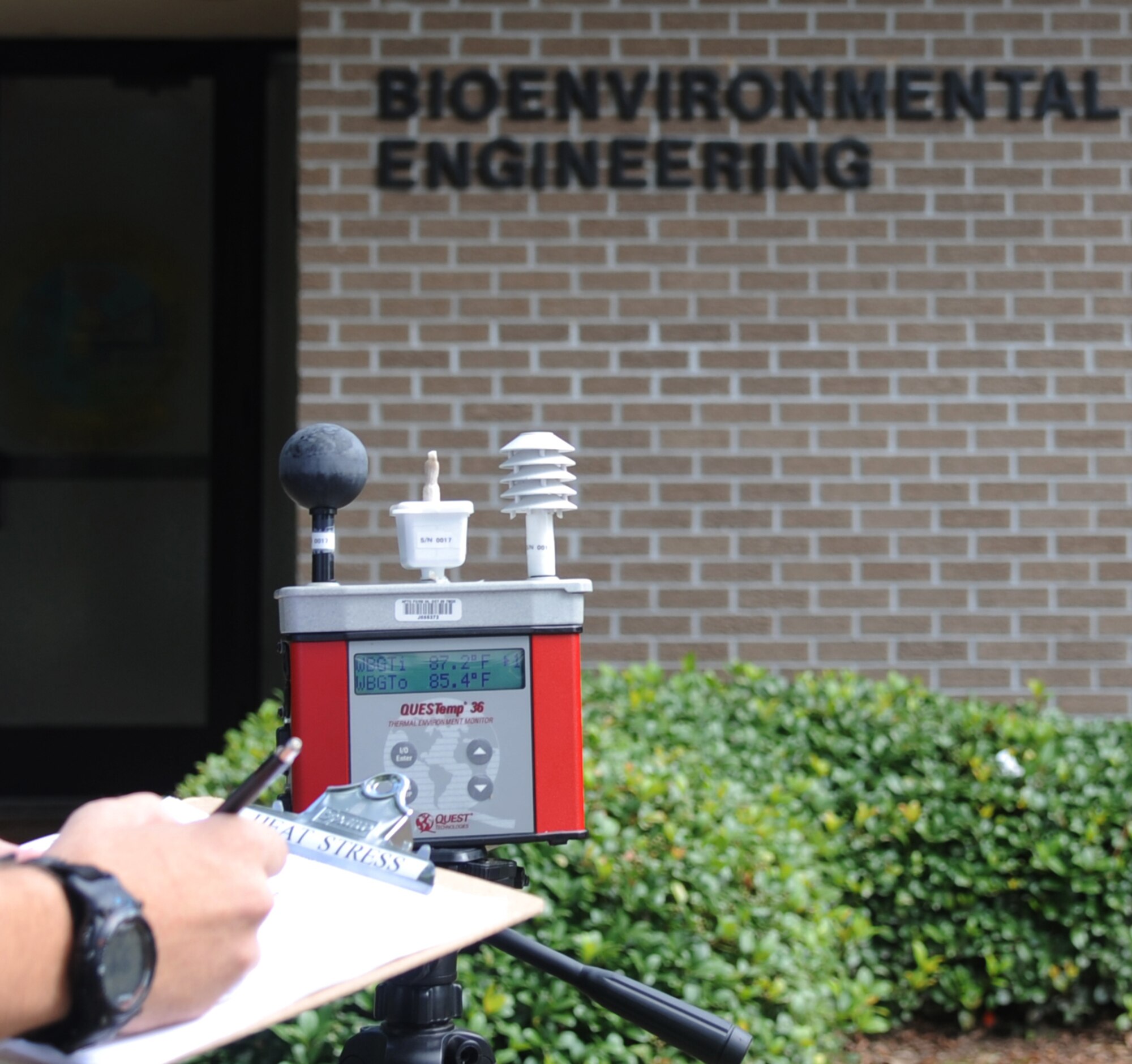 A wet bulb globe temperature reading is recorded July 21, 2014, in front of the bioenvironmental engineering building at Keesler Air Force Base, Miss. A WBGT reading determines the heat category and work/rest cycles for the base. (U.S. Air Force photo by Kemberly Groue)