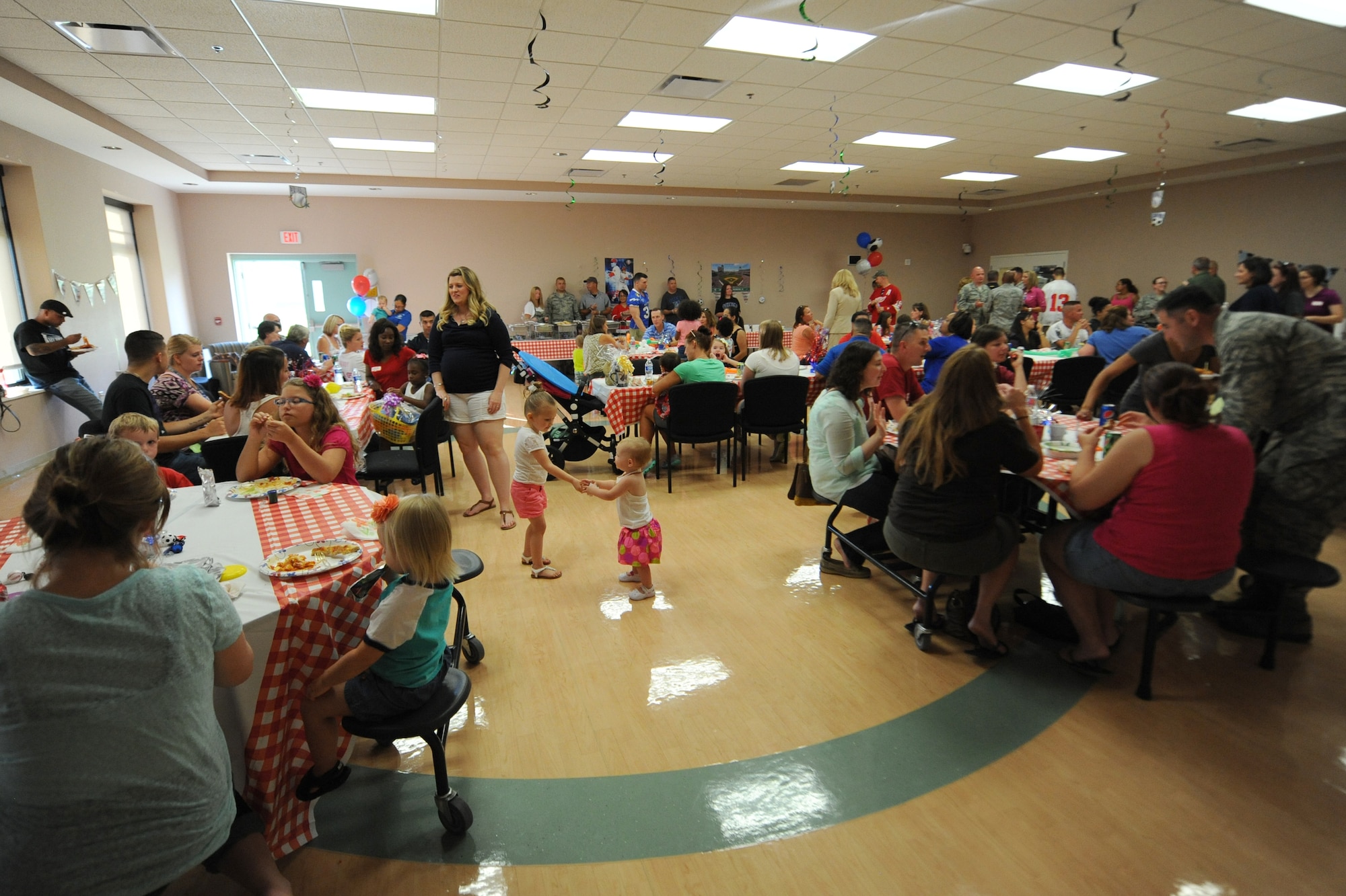 Families of deployed Team Dover Airmen enjoy a dinner hosted by the 436th Maintenance Group at the Youth Center July 17, 2014 at Dover Air Force Base, Del. The All-American sports themed event included dinner, face painting, put-put golf and other activities. (U.S. Air Force photo/Staff Sgt. Elizabeth Morris)