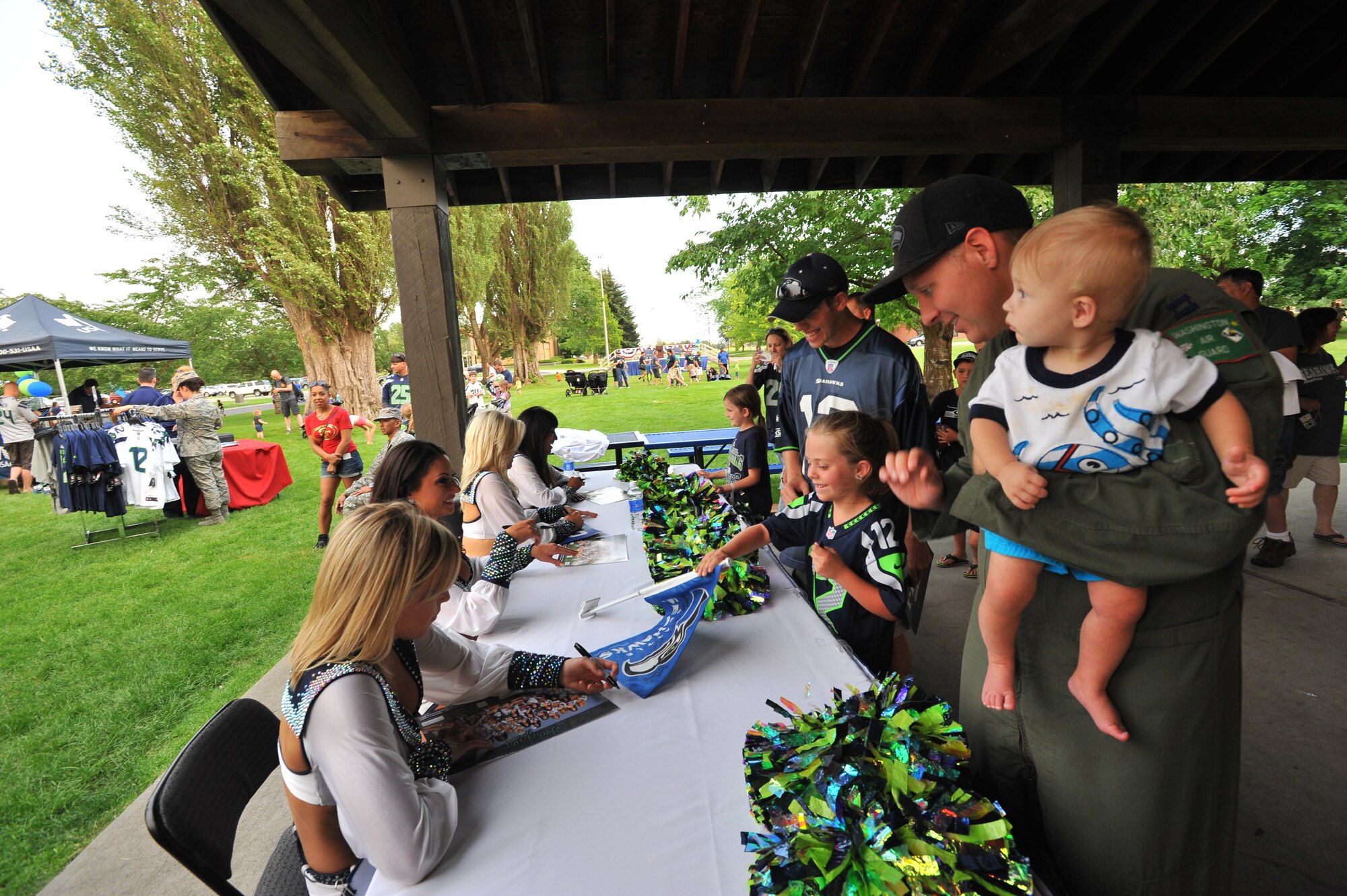 The Sea Gal cheerleaders from the National Football League team the Seattle Seahawks perform for fans July 18, 2014, at Fairchild Air Force Base, Wash.  The Superbowl champions were here as part of their “Heroes of 12” tour.  (U.S. Air Force photo by Staff Sgt. Veronica Montes/Released)