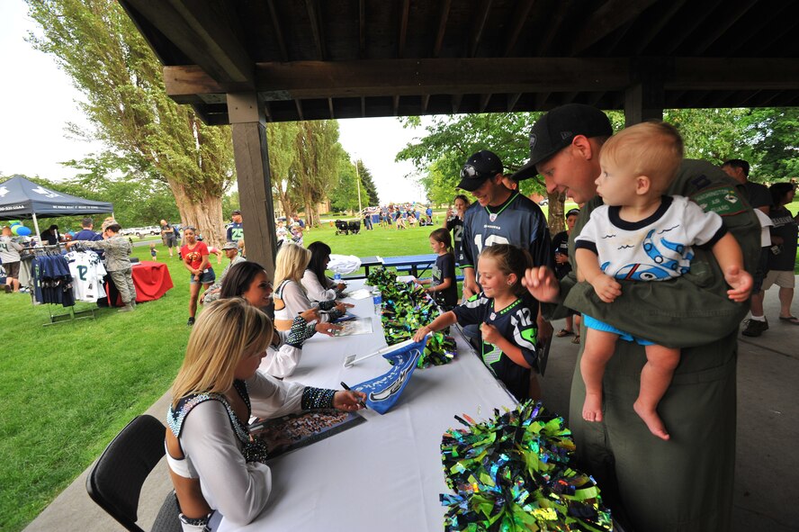 The Sea Gal cheerleaders from the National Football League team the Seattle Seahawks perform for fans July 18, 2014, at Fairchild Air Force Base, Washington. The Superbowl champions were here as part of their “Heroes of 12” tour. (U.S. Air Force photo/Staff Sgt. Veronica Montes)
