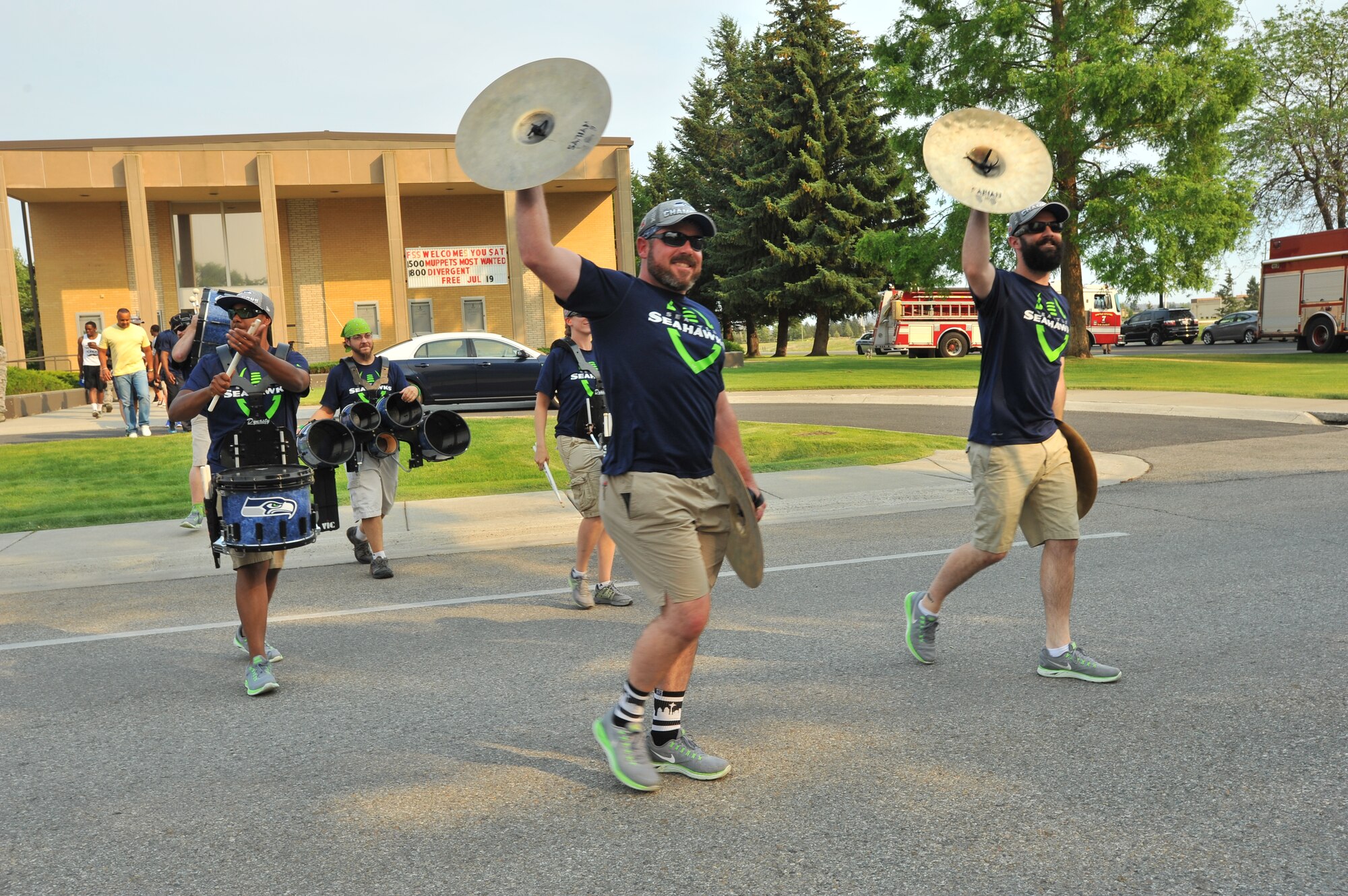 Members of the Blue Thunder band from the Seattle Seahawks dance into the crowd July 18, 2014, at Fairchild Air Force Base, Wash.  The Superbowl champions were here as part of their “Heroes of 12” tour.  (U.S. Air Force photo by Staff Sgt. Veronica Montes/Released)