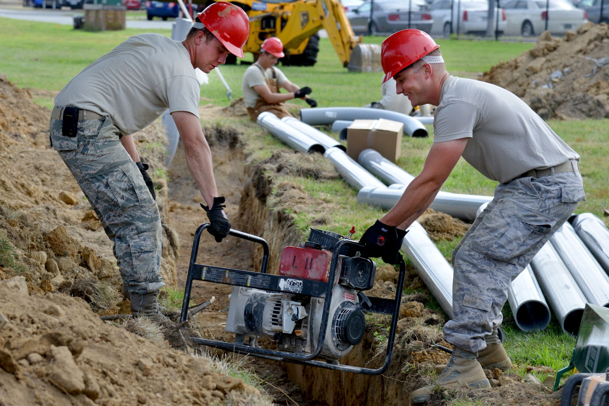 U.S. Air Force Staff Sgt. Andrew Goodrick, left, and Senior Airman Paul Dowdell, both 820th Rapid Engineer Deployable Heavy Operational Repair Squadron Engineer electricians from Nellis Air Force Base, Nev., transfer a generator from one side of a ravine to another at Langley Air Force Base, Va., July 22, 2014. REDHORSE engineers provide heavy-repair capability and construction support when requirements exceed normal base civil engineer squadron capabilities. (U.S. Air Force photo by Senior Airman Aubrey White/Released)