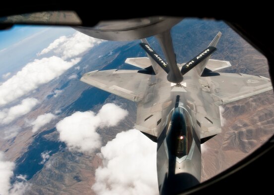 A U.S. Air Force F-22 Raptor assigned to the 325th Fighter Wing, Tyndall Air Force Base, Fla., moves into position for mid-air refueling over the Nevada Test and Training Range with a KC-135 Stratotanker from the 93rd Air Refueling Squadron, Fairchild AFB, Wash., during Red Flag 14-3, July 17, 2014. Red Flag provides realistic combat training in a contested, degraded and operationally limited environment. These stressors provide aircrews with real-time war scenarios and helps ground crews test and improve their operational readiness. (U.S. Air Force photo by Airman 1st Class Thomas Spangler)