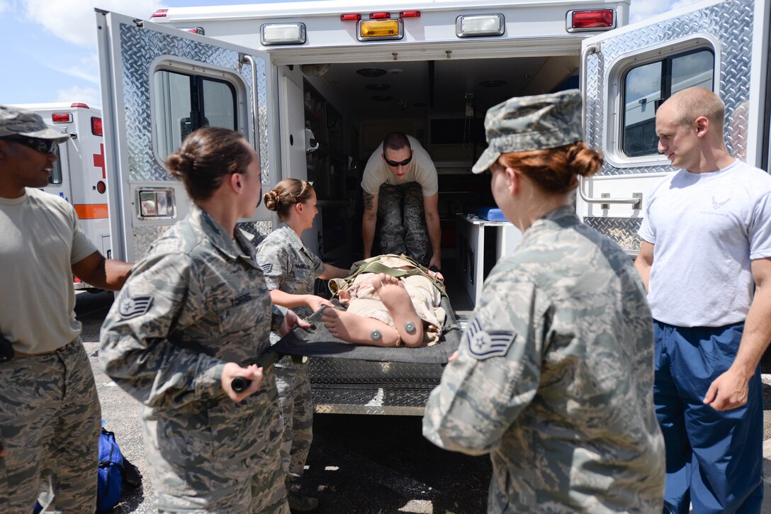 Airmen assigned to the 28th Medical Group practice loading patients into an ambulance at Ellsworth Air Force Base, S.D., July 16, 2014, during a training exercise. The exercise was designed to test participant’s ability to respond to emergency situations. (U.S. Air Force photo by Senior Airman Zachary Hada/Released)