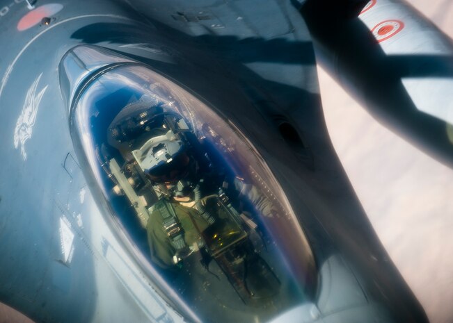 A U.S. Air Force F-16 Fighting Falcon pilot assigned to the 20th Fighter Wing, Shaw Air Force Base, S.C., moves his aircraft into position for in-flight refueling mission during Red Flag 14-3, July 17, 2014, over the Nevada Test and Training Range. A typical Red Flag exercise involves a variety of attack, fighter and bomber, reconnaissance, electronic warfare, air superiority, airlift support, search and rescue, aerial refueling and command and control aircraft. (U.S. Air Force photo by Airman 1st Class Thomas Spangler)