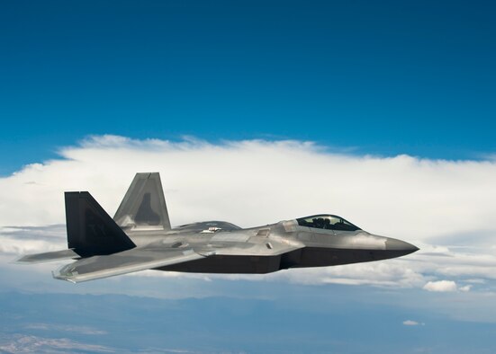 A U.S. Air Force F-22 Raptor assigned to the 325th Fighter Wing, Tyndall Air Force Base, Fla., flies alongside a KC-135 Stratotanker assigned to the 93rd Air Refueling Squadron, Fairchild AFB, Wash., during Red Flag 14-3, July 17, 2014, over the Nevada Test and Training Range. The F-22 is an air-superiority supersonic fighter aircraft capable of reaching speeds twice the speed of sound, and carries a variety of air-to-air and air-to-ground munitions. (U.S. Air Force photo by Airman 1st Class Thomas Spangler)