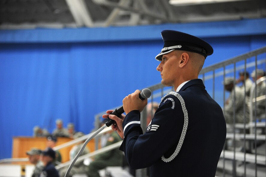Senior Airman Nicholas Priest provides naration during the Air Force District of Washington change of command ceremony at Joint Base Andrews, Maryland, July 22, 2014. During the ceremony Maj. Gen. Darryl W. Burke assumed command of AFDW from Maj. Gen. Sharon K. G. Dunbar. Priest is a U.S. Air Force Honor Guard Color Team member and narrator. (U.S. Air Force photo/Master Sgt. Tammie Moore)