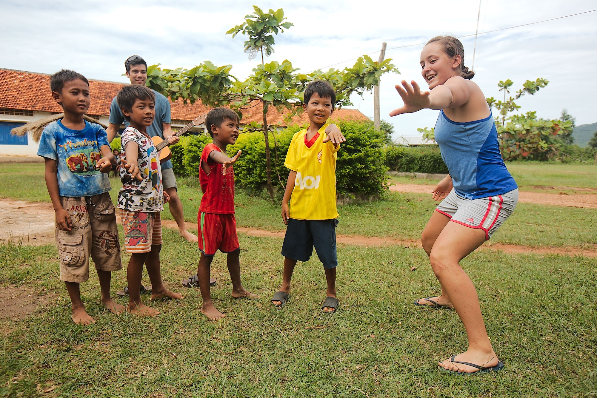 Cadet 2nd Class Hansena Vangen teaches Cambodia children the "Hokey Pokey" during a recent Academy Cultural Immersion Program trip to Cambodia. While there, the cadets built latrines in Cambodian villages, took in historical sites and spent time with Cambodian citizens. (U.S. Air Force photo)