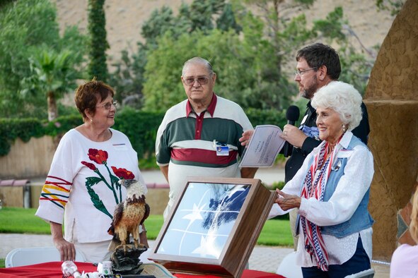 Civ-Mil presented their host, Francis Lane (left) with an 18-foot by 22-foot garrison flag in a custom-built cabinet to show their appreciation for her hospitality. The flag was flown in 13 different military aircraft leading up to the annual Edwards Civ-Mil Group barbeque July 18. (U.S. Air Force photo by Rebecca Amber)