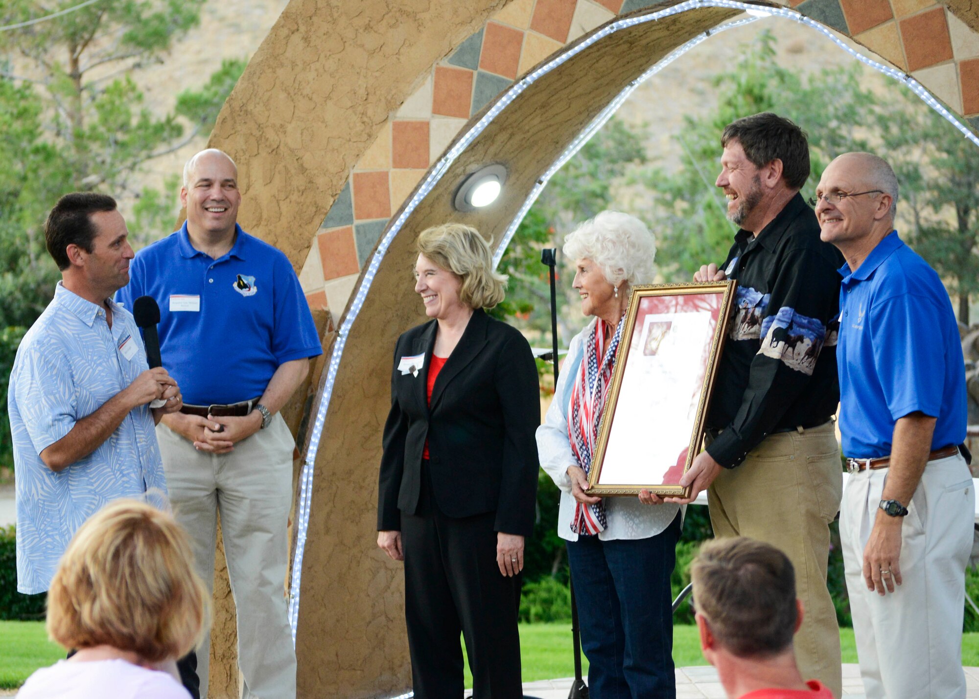 California State Senator Steve Knight (left) was joined by Brig. Gen. Michael Brewer, 412th Test Wing commander, and Maj. Gen. Arnold Bunch, Air Force Test Center commander, to present Civ-Mil founder Aida O’Connor with a resolution, recognizing the work that Civ-Mil has done and continues to do for Edwards AFB. (U.S. Air Force photo by Rebecca Amber)