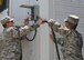 Master Sgt. Michael Miller and Staff Sgt. Timothy Blake, 436th Civil Engineer Squadron power production, remove cables from a refrigeration trailer prior to its removal July 21, 2014 from the Charles C. Carson Center for Mortuary Affairs, Dover Air Force Base, Del. Air Force Mortuary Affairs Operations transitioned to a more cost-effective internal refrigeration unit. (U.S. Air Force photo/Christin Michaud)