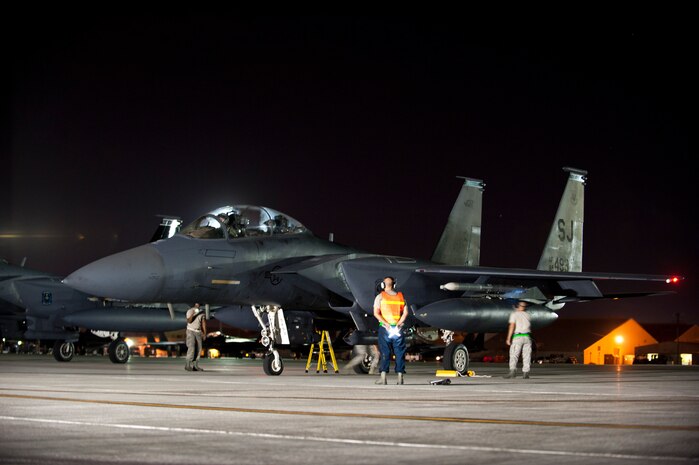 U.S. Air Force aircraft maintainers assigned to the 4th Fighter Wing from Seymour Johnson Air Force Base, N.C., preform final pre-flight checks on an F-15 Eagle from the 4th Fighter Wing during Red Flag 14-3, July 16, 2014, at Nellis AFB, Nev.  Night missions have been integrated into Red Flag to prepare pilots and aircrews for missions in low-visibility environments. (U.S. Air Force photo by Airman 1st Class Thomas Spangler)