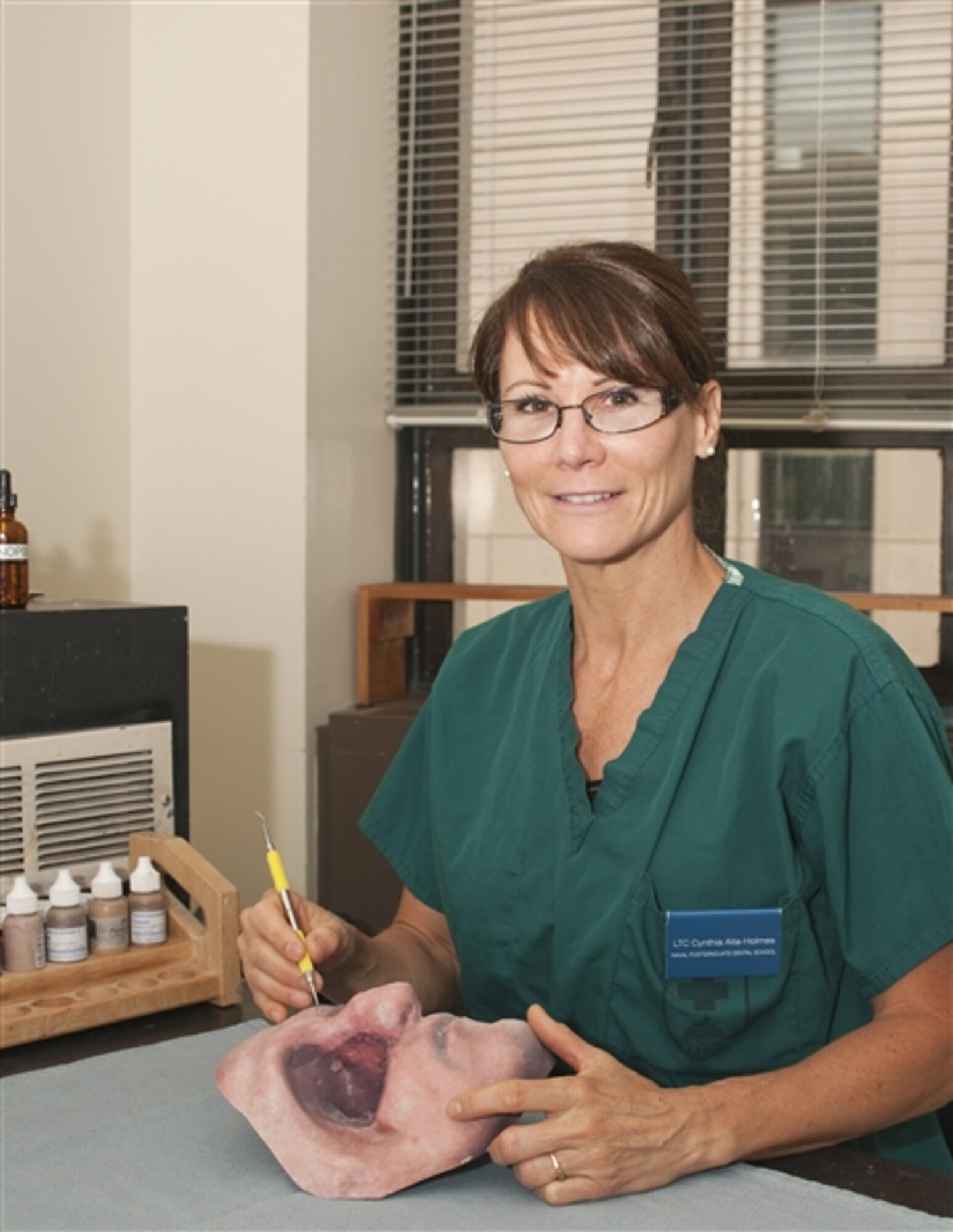 Army Lt. Col. Cynthia Aita-Holmes creates synthetic body parts from molds cast into silicone that are painted to match the unique characteristics of a person's face. In best-case scenarios, the transition from skin to silicone is nearly indiscernible. Aita-Holmes is a maxillofacial prosthodontist who earned her master's degree from the Postgraduate Dental College at the Uniformed Services University of the Health Sciences in Bethesda, Maryland. (DoD photo/Thomas C. Balfour)