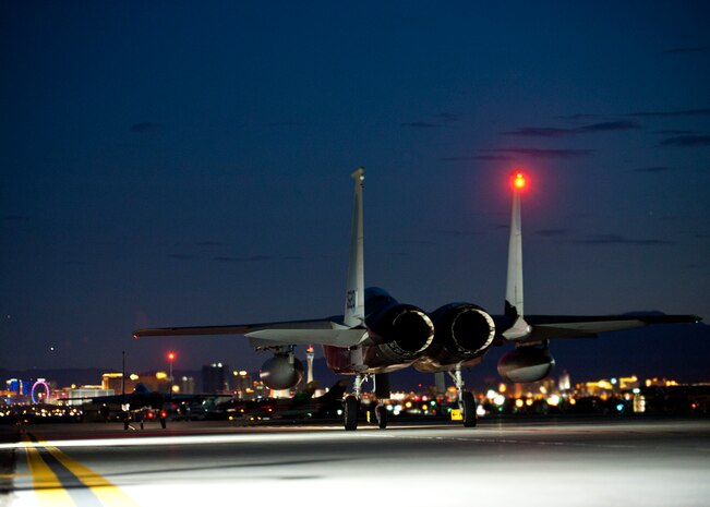 Two U.S. Air Force F-15 Eagles from the 65th Aggressor Squadron, taxi to the runway for night operations during Red Flag 14-3, July 16, 2014, at Nellis Air Force Base, Nev. Former Tactical Air Command Gen. Robert Dixon established Red Flag in 1975 to better prepare airmen for combat missions. Because many real-world combat missions occur at night, training during the hours of darkness is vital to preparing for future real-world missions. (U.S. Air Force photo by Airman 1st Class Thomas Spangler)