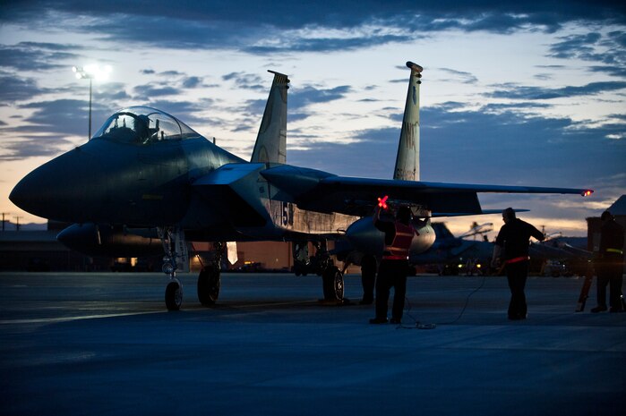 U.S. Air Force aircraft maintainers from the 757th Aircraft Maintenance Squadron Flanker Aircraft Maintenance Unit, go through final pre-flight checks on a 65th Aggressor Squadron F-15C Eagle during Red Flag 14-3, July 16, 2014, at Nellis Air Force Base, Nev. The 65th AGRS act as adversaries to participating units in the Red Flag exercises. They provide this threat by replicating the weapons and tactics of the adversaries of the U.S. and allied nations. (U.S. Air Force photo by Airman 1st Class Thomas Spangler)