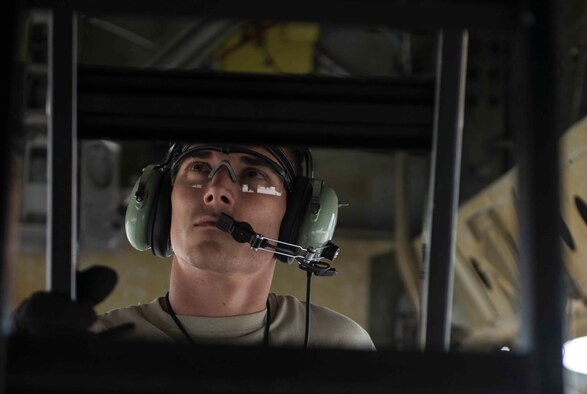Senior Airman Matthew Brimmer, 5th Aircraft Maintenance weapons load crew member, climbs a ladder to inspect the under carriage of a B52-H Stratofortress during a load crew competition on Minot Air Force Base, N.D., July 11, 2014. Brimmer and his four-man crew competed against another crew for the title of load crew of the quarter. (U.S. Air Force photos/Airman 1st Class Lauren Pitts)  