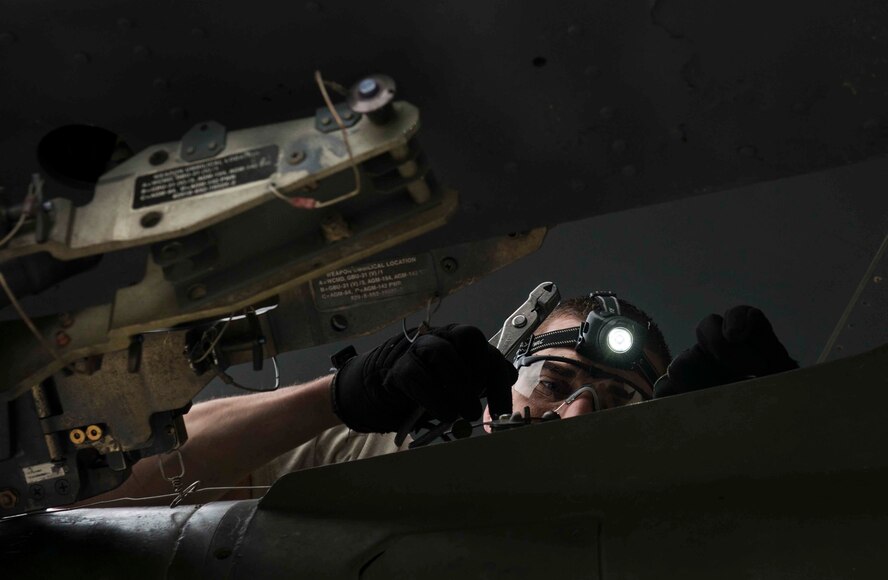 Senior Airman Matthew Brimmer, 5th Aircraft Maintenance Squadron weapons load crew member, inspects a bomb rack during a load crew competition on Minot Air Force Base, N.D. The competition is meant to incite enthusiasm and morale amongst the Airmen, as they strive for the title of load crew of the quarter. (U.S. Air Force photos/Airman 1st Class Lauren Pitts) 