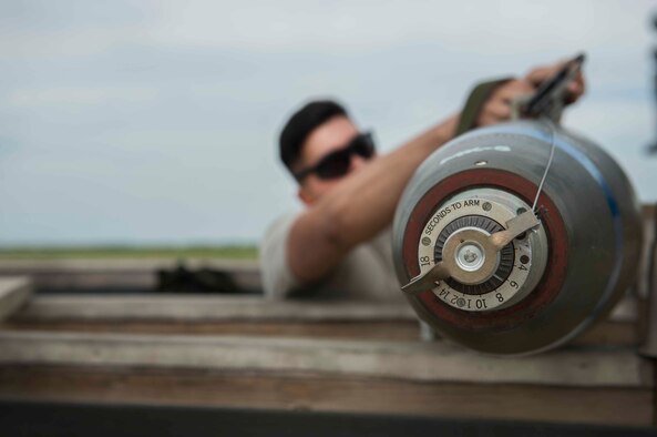 Airman Filipe Castro, Minot Air Force Base, N.D., 5th Aircraft Maintenance Squadron weapons load crew member, prepares to load a bomb during a load crew competition July 11, 2014. The competitions are meant to boost Airman morale and incite competition in the work area. (U.S. Air Force photos/Airman 1st Class Lauren Pitts) 
