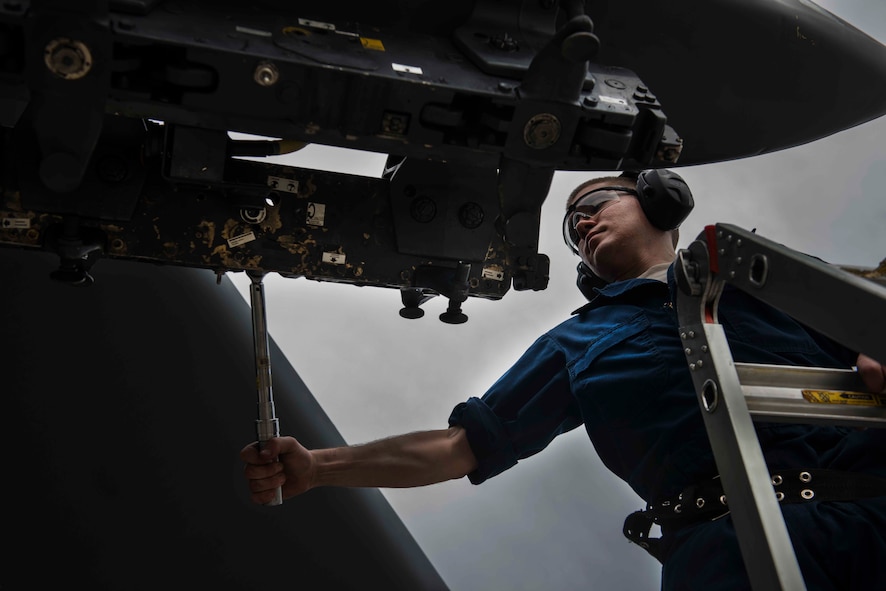 Senior Airman Jason Byrge, a weapons load crew member with the Minot Air Force Base, N.D., 5th Aircraft Maintenance Squadron, tightens a bolt on a bomb-rack during a bomb-loading crew competition July 11, 2014. Working as safely and quickly as possible, the teams compete for the title of load crew of the quarter. (U.S. Air Force photo/Airman 1st Class Lauren Pitts)  