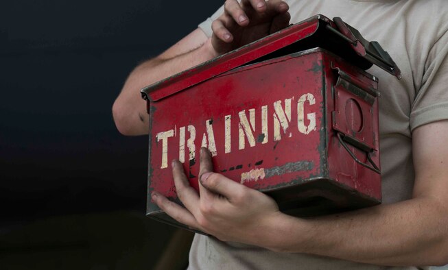 A weapons load crew member from Minot Air Force Base, N.D., 5th Aircraft Maintenance Squadron, carries a tool box across the flight line during a bomb-loading crew competition July 11, 2014. The morale-building competition is meant to inspire Airmen to strive for excellence, while performing a job as safely and quickly as possible. (U.S. Air Force photos/Airman 1st Class Lauren Pitts)   