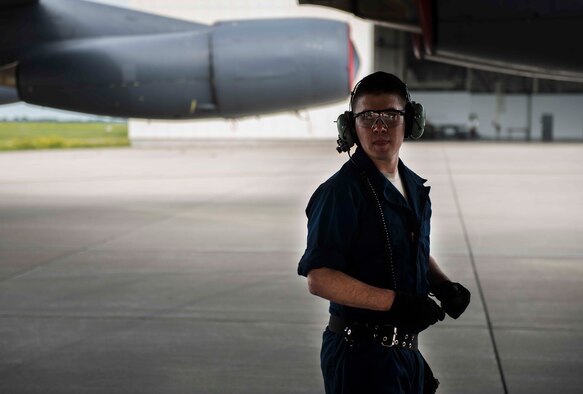 Senior Airman Jason Byrge, a weapons load crew member with the Minot Air Force Base, N.D., 5th Aircraft Maintenance Squadron, walks underneath a B52-H Stratofortress during a bomb-loading crew competition July 11, 2014. The competitions are part of a morale building exercise to encourage each crew to strive for excellence. (U.S. Air Force photos/Airman 1st Class Lauren Pitts)