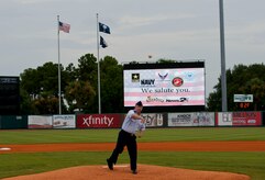 Col. Jeffrey DeVore, Joint Base Charleston commander, delivers the ceremonial first pitch during Military Appreciation Night July 19, 2014, at Joseph P. Riley Jr. ballpark in Charleston, S.C. The Charleston RiverDogs hosted Military Appreciation Night to show their support for the local military. (U.S. Air Force photo/ Staff Sgt. William A. O’Brien)