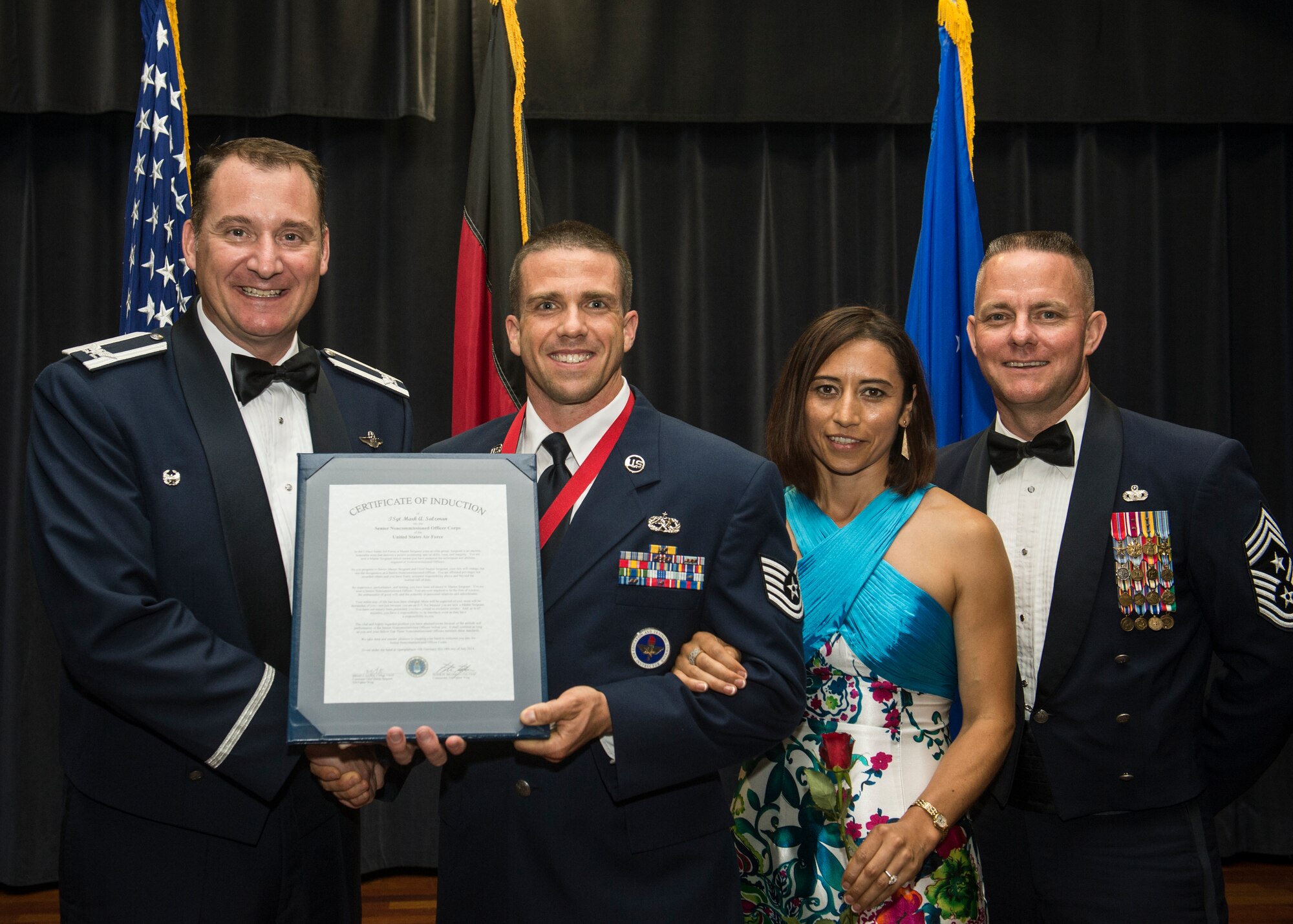 (From left to right) U.S. Air Force Col. Peter Bilodeau, 52nd Fighter Wing commander, Tech. Sgt. Mark Salzman, 327th Detachment 17 F-16 section chief and Sunrise, Fla., native, Nancy Salzman, and Chief Master Sgt. Brian Gates, 52nd FW command chief, pose for a photo during the Senior NCO Induction Ceremony July 18, 2014, at Spangdahlem Air Base, Germany. The ceremony featured the induction of more than 60 technical sergeants and a master sergeant who earned a promotion to the rank of master sergeant. (U.S. Air Force photo by Senior Airman Rusty Frank/Released)