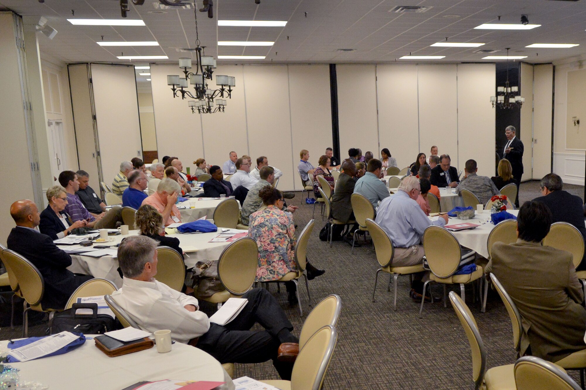 Randall May, 20th FW Small Business Program Manager and director of business operations speaks to a room filled with visitors during the small business opportunity forum at Shaw Air Force Base, S.C., July 16, 2014. Shaw’s annual forum is an outreach event supporting of the Air Force’s Small and Disadvantaged Business Utilization Program. (U.S. Air Force photo by Senior Airman Ashley L. Gardner/Released) 
