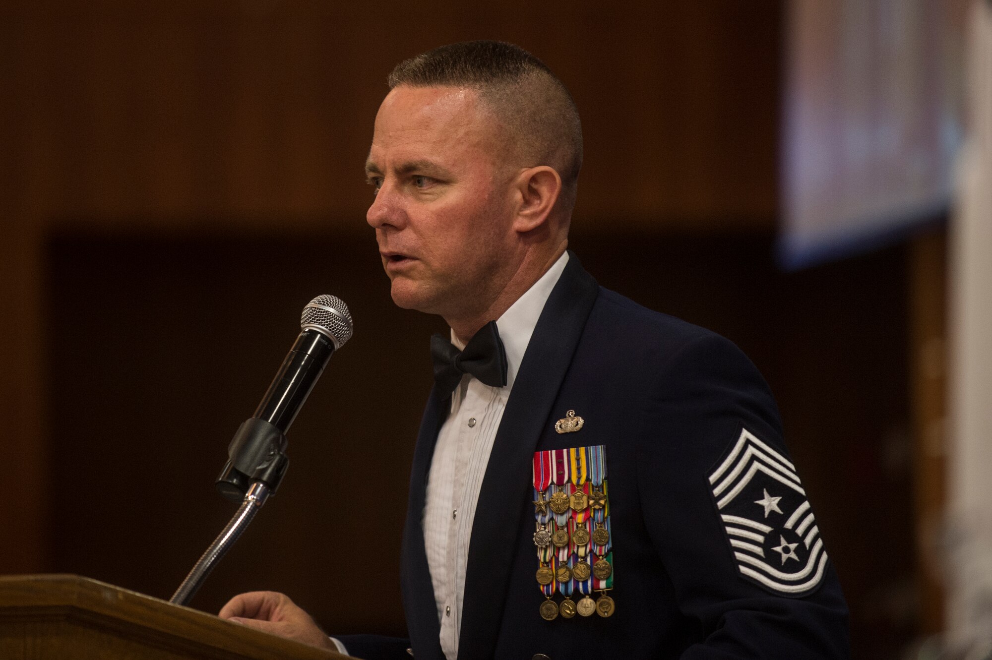 U.S. Air Force Chief Master Sgt. Brian Gates, 52nd Fighter Wing command chief, speaks during the Senior NCO Induction Ceremony July 18, 2014, at Spangdahlem Air Base, Germany. Gates served as the guest speaker for the event. (U.S. Air Force photo by Senior Airman Rusty Frank/Released)