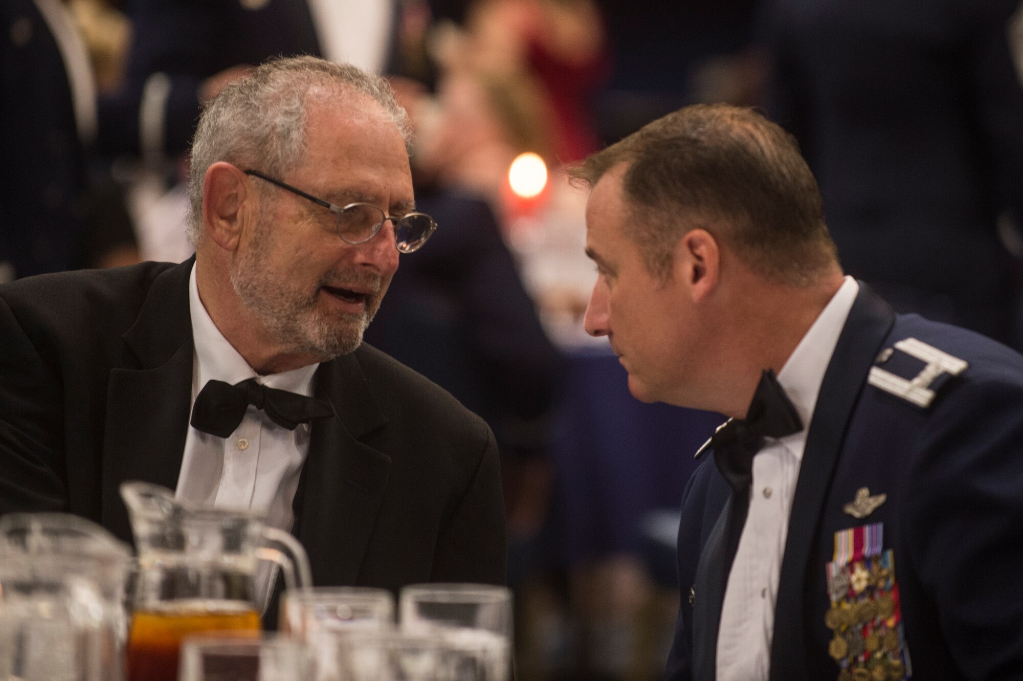 U.S. Air Force Col. Peter Bilodeau, 52nd Fighter Wing commander, speaks with Robert Mandell, U.S. ambassador to Luxembourg, during the Senior NCO Induction Ceremony July 18, 2014, at Spangdahlem Air Base, Germany. The ambassador served as a member of the official party during ceremony. (U.S. Air Force photo by senior Airman Rusty Frank/Released)
