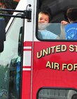 A young boy receives a ride in a fire truck during the North Dakota State parade in Minot, N.D., July 19, 2014. Organizations from Minot and all over the state drove their floats down Burdick Expressway for the parade. (U.S. Air Force photo/Senior Airman Brittany Y. Bateman)