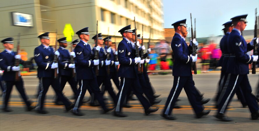 The Minot Air Force Base Honor Guard marches in formation during the North Dakota State parade in Minot, N.D., July 19, 2014. Some highlights of the parade included military tributes, tunes from area musical groups and a row of classic cars, including Ford models dating back to the 1920s. (U.S. Air Force photo/Senior Airman Brittany Y. Bateman)