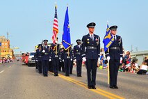 The Minot Air Force Base Honor Guard presents the colors during the North Dakota State parade in Minot, N.D., July 19, 2014. Some highlights of the parade included military tributes, tunes from area musical groups and a row of classic cars, including Ford models dating back to the 1920s. (U.S. Air Force photo/Senior Airman Brittany Y. Bateman)