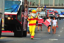 Sparky the fire dog walks down the parade line during the North Dakota State parade in Minot, N.D., July 19, 2014. Organizations from Minot and all over the state drove their floats down Burdick Expressway for the parade. (U.S. Air Force photo/Senior Airman Brittany Y. Bateman)