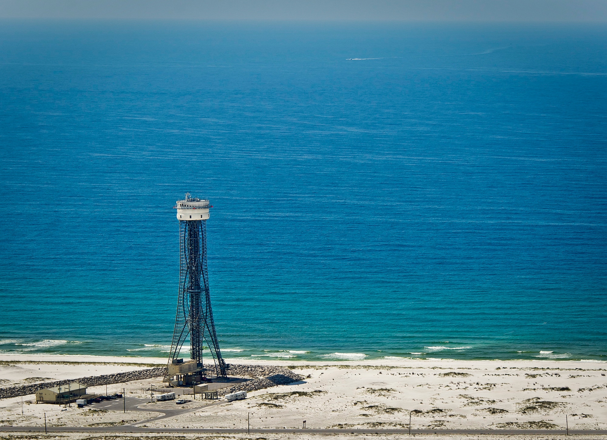 Eglin's Santa Rosa Island tower stands tall during a sunny day in Northwest Florida. The SRI tower is a 300-foot free-standing tower located on Santa Rosa Island at TA A-13B on Eglin Air Force Base, Fla. It overlooks the Eglin Gulf Test and Training Range to the south and the Eglin land ranges to the north. This unique structure provides two important capabilities which include open-air hardware-in-the-loop testing for the development of precision-guided weapons and evaluation in real-world environments; and improved line of sight and coverage for test missions in the Gulf of Mexico. (U.S. Air Force photo/Sara Vidoni)