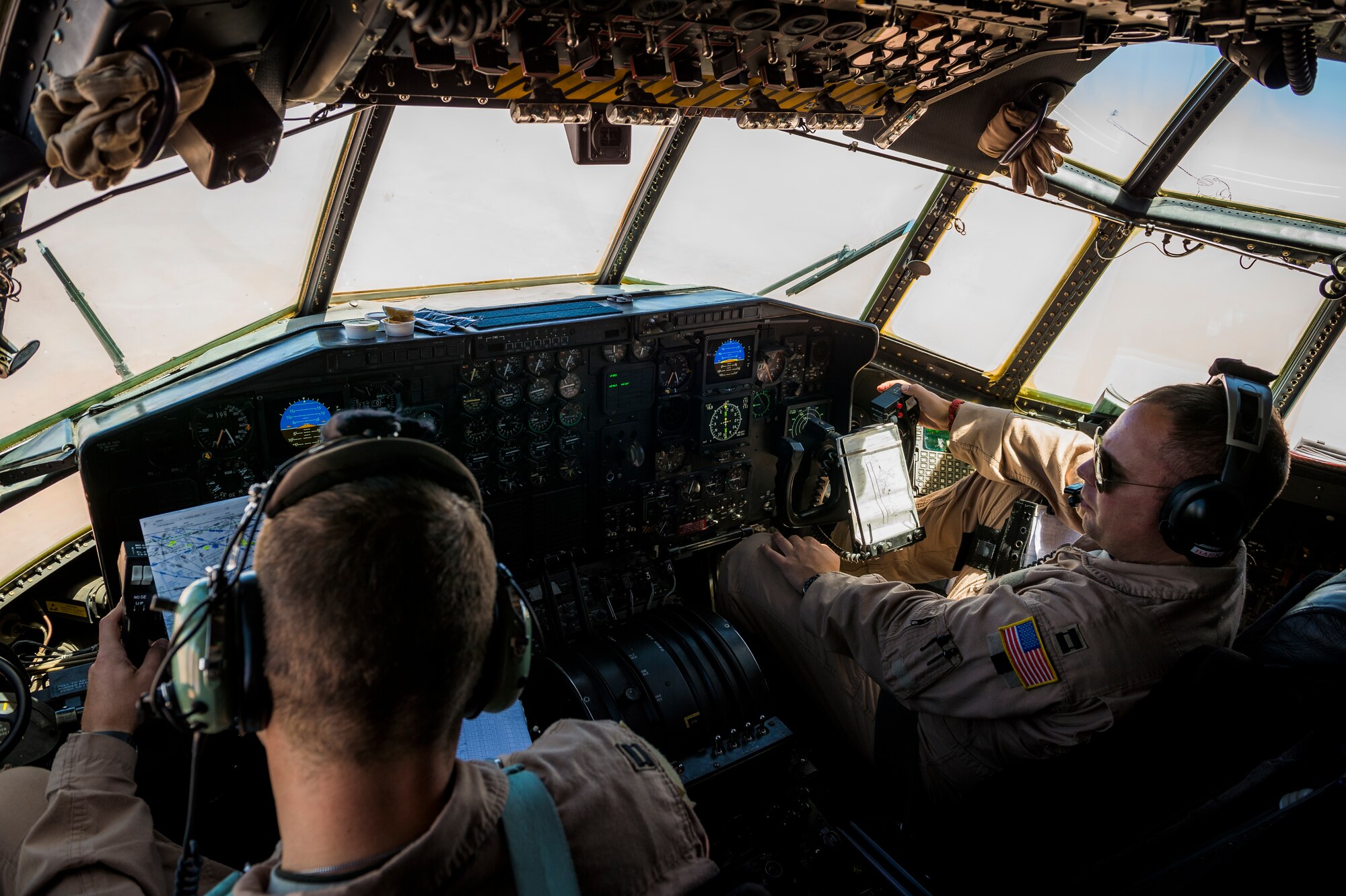 U.S. Air Force Captains Ronald Barr (left) and Steven Stroney (right), 737th Expeditionary Airlift Squadron C-130H pilots, fly a C-130H Hercules July 20, 2014 at an undisclosed location in Southwest Asia. Both Airmen deployed here from the 910th Airlift Wing, Youngstown Air Reserve Station, Ohio in support of Operation Enduring Freedom. (U.S. Air Force photo by Staff Sgt. Jeremy Bowcock)