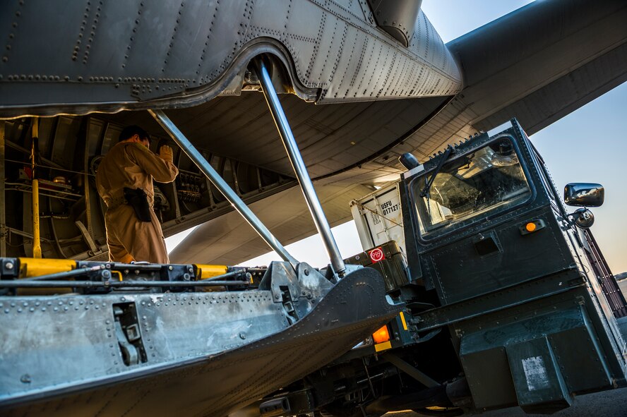 U.S. Air Force Master Sgt. Scott Francesangeli, 737th Expeditionary Airlift Squadron C-130H loadmaster, directs a K-loader to the back of a C-130H Hercules July 20, 2014 at an undisclosed location in Southwest Asia. Loadmasters ensure all cargo and personnel to be transported on a plane are secured and properly placed to ensure the plane can safely fly. Francesangeli deployed here from the 910th Airlift Wing, Youngstown Air Reserve Station, Ohio in support of Operation Enduring Freedom. (U.S. Air Force photo by Staff Sgt. Jeremy Bowcock)