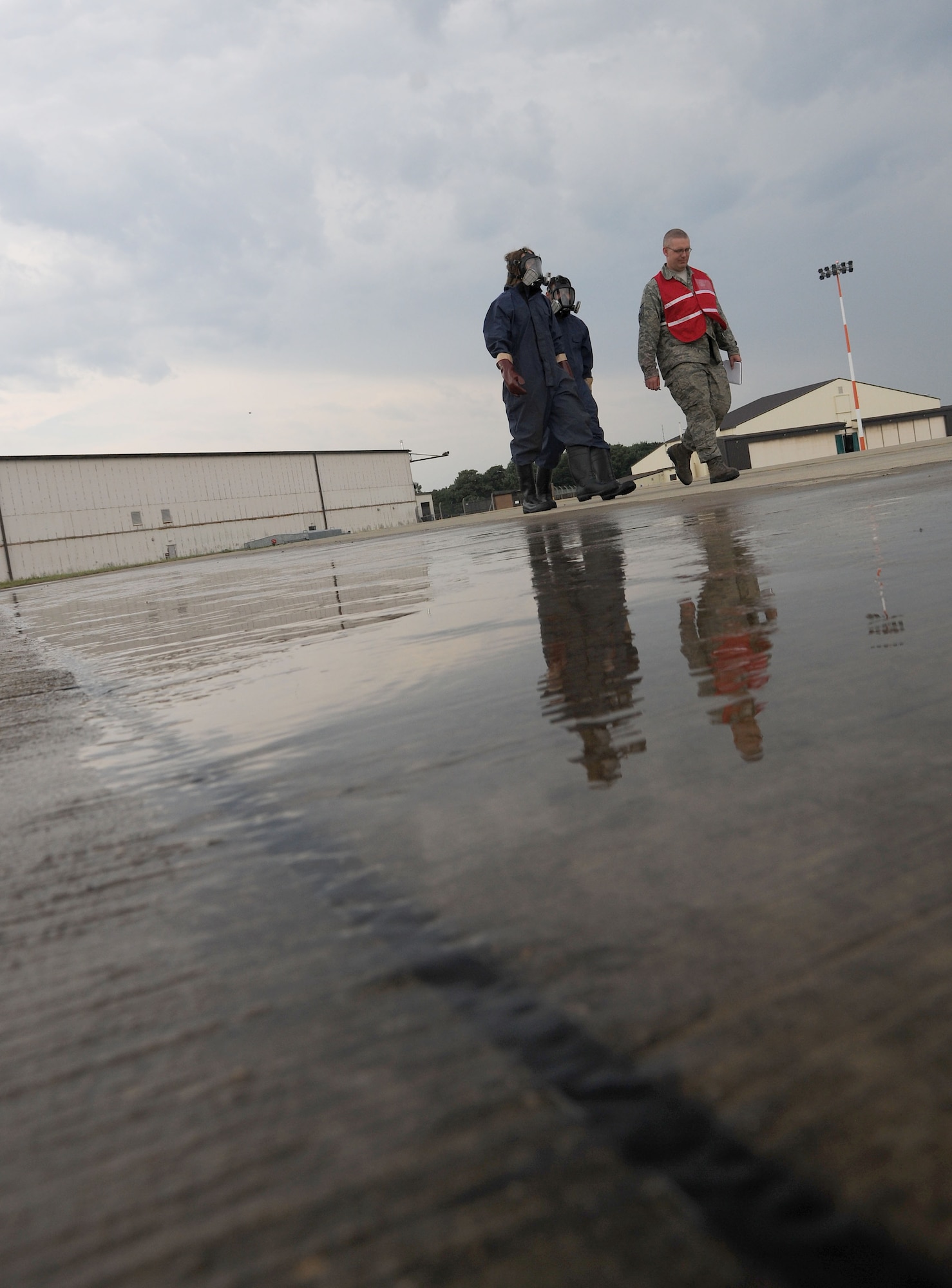 U.S. Air Force Tech. Sgt. Eric Wise, right, 100th Civil Engineer Squadron Fuel Systems Maintenance NCO in charge and wing inspection team member from Dakota, Ill., walks through necessary procedures following a simulated fuel spill with Adam Powell and Zach Murfitt, 100th CES Fuel Systems Maintenance technicians, during a fuel spill exercise July 18, 2014, on RAF Mildenhall, England. The exercise tested Airmen’s ability to respond to a stressful situation quickly. (U.S. Air Force photo/Senior Airman Kate Maurer/Released)