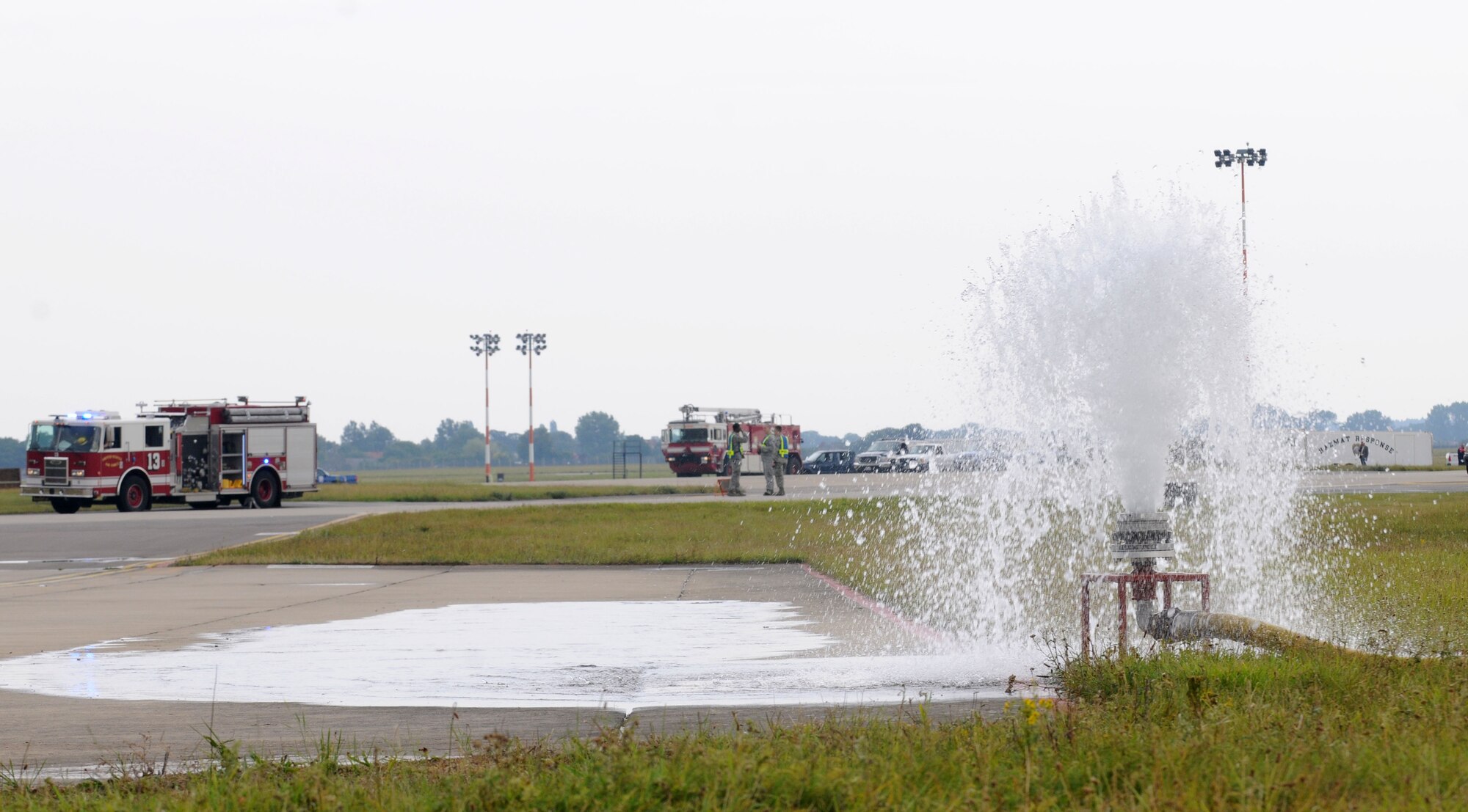 Water erupts from a hydrant simulating a damaged fuel system during a fuel spill exercise July 18, 2014, on RAF Mildenhall, England. Exercises like this test the ability of different units including the 100th Civil Engineer Squadron Fire Department, 100th Security Forces Squadron and 100th CES Fuel Systems Maintenance to work together to respond quickly and safely to real-world situations. (U.S. Air Force photo/Senior Airman Kate Maurer/Released)