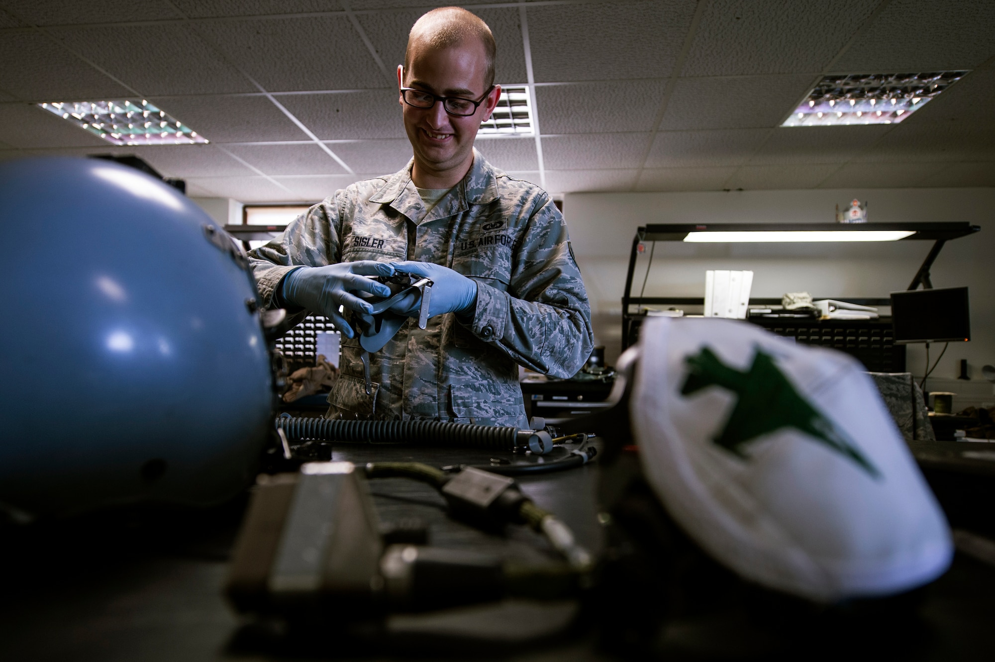 U.S. Air Force Daniel Sisler, a 52nd Operations Support Squadron air crew flight equipment technician from Somerset, Wis., performs a periodic 30-day inspection on a pilot’s helmet July 15, 2014, at Spangdahlem Air Base, Germany. AFE members are responsible for maintaining and fitting all pilots with their equipment. (U.S. Air Force photo by Senior Airman Rusty Frank/Released)