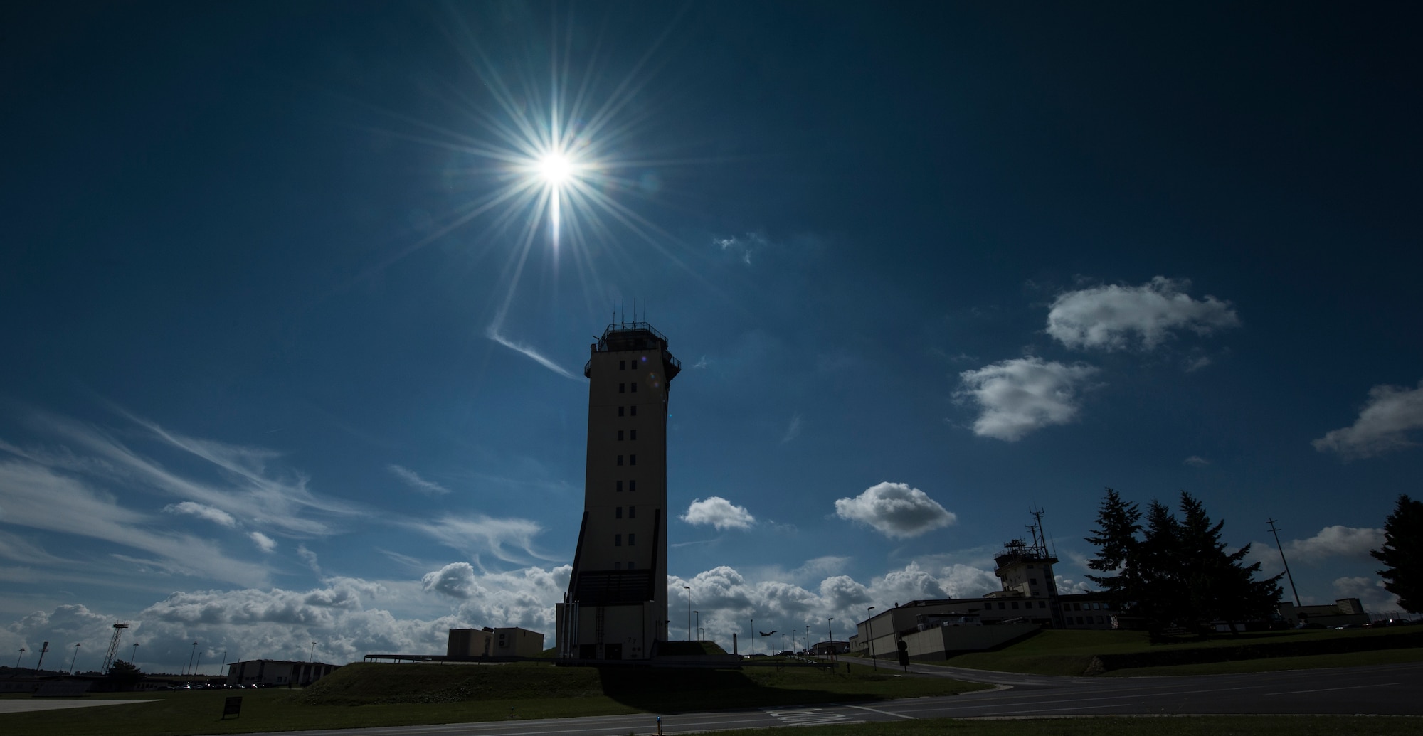 An F-16 Fighting Falcon fighter aircraft takes off in front of the base tower July 15, 2014 at Spangdahlem Air Base, Germany. The 52nd Operations Support Squadron comprises of six flights that all directly impact the flying mission of the 52nd Fighter Wing. (U.S. Air Force photo by Senior Airman Rusty Frank/Released)