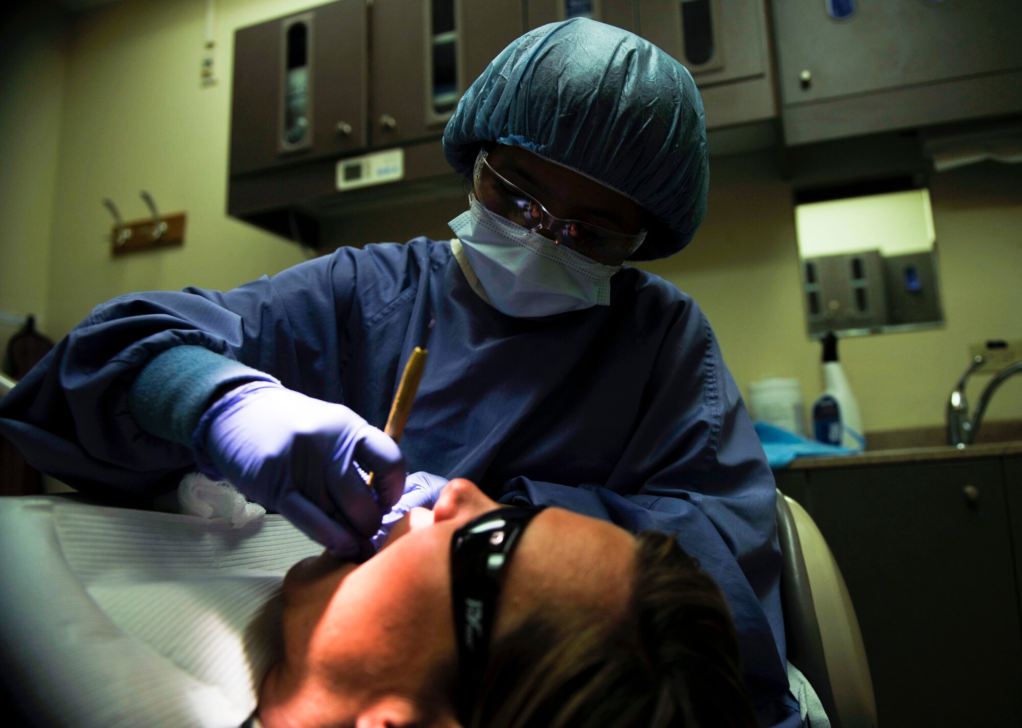 Staff Sgt. Janice Gonzales, 51st Dental Squadron prophylaxis technician, cleans the teeth of Senior Master Sgt. Kathleen Ross, 51st Security Forces Squadron first sergeant, during her annual dental examination on Osan Air Base, Republic of Korea, July 16, 2014. (U.S. Air Force photo by Senior Airman David Owsianka)